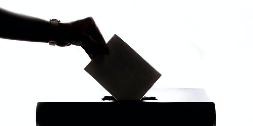 Voting in a ballot box silhouette